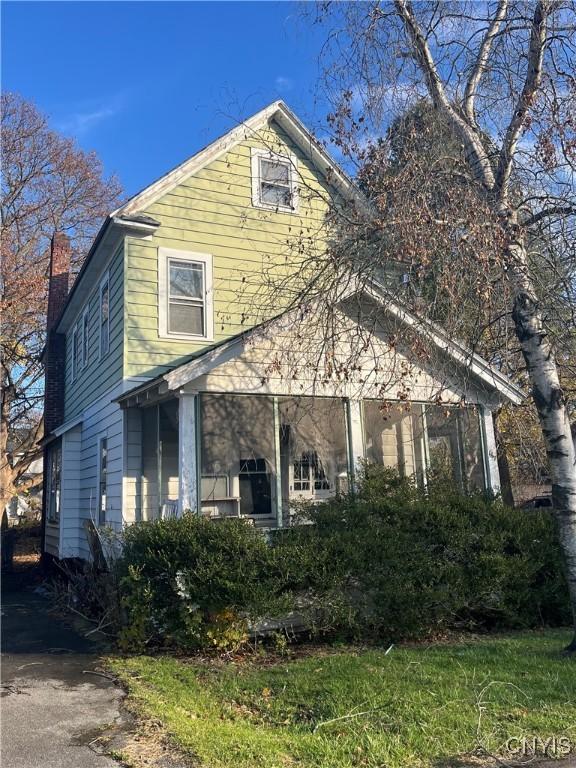 view of side of home featuring a chimney