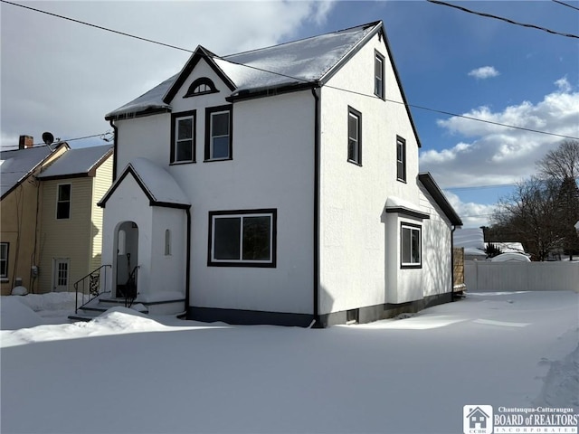 view of front of home with fence and stucco siding