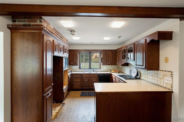 kitchen with light countertops, glass insert cabinets, beamed ceiling, a peninsula, and black appliances