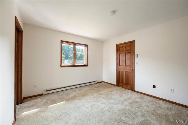 empty room featuring light carpet, a baseboard radiator, and baseboards