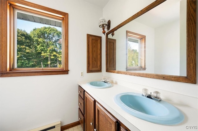 bathroom featuring double vanity, a wealth of natural light, and a sink