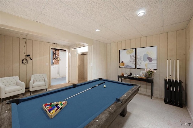 recreation room with carpet, a paneled ceiling, pool table, wood walls, and baseboards