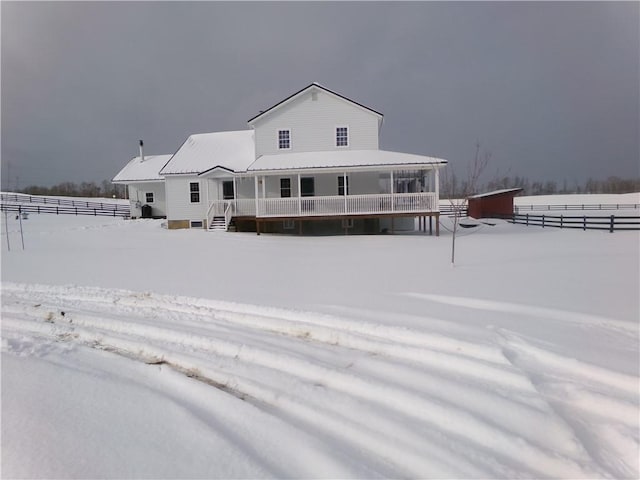 snow covered house with metal roof