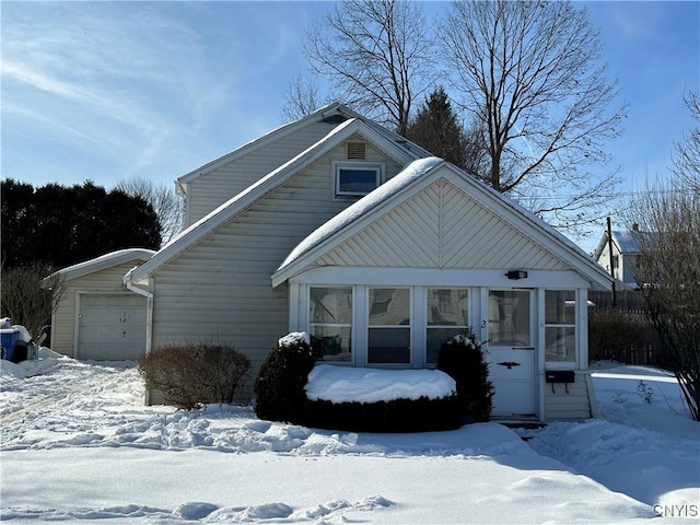 view of front of property featuring a sunroom and an attached garage