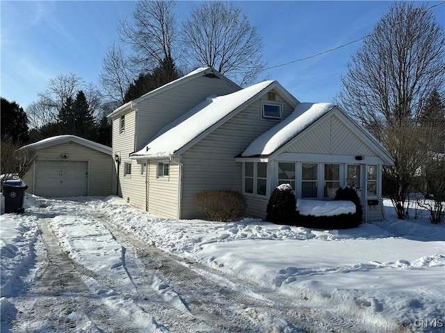 view of front facade featuring a garage and an outbuilding