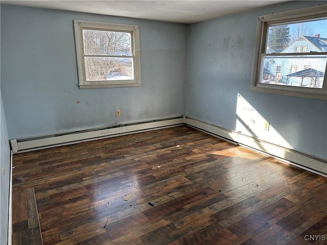 spare room featuring a wealth of natural light and dark wood-style flooring