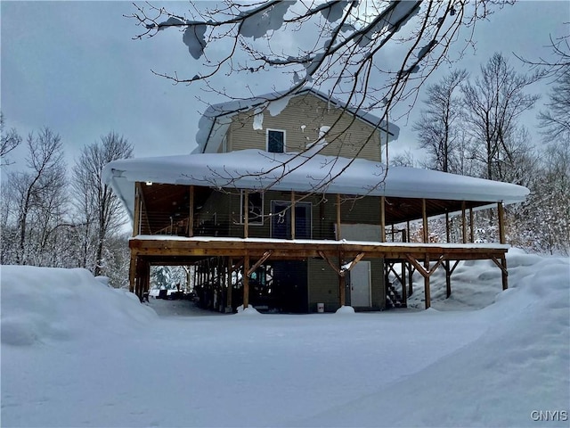 view of snow covered rear of property