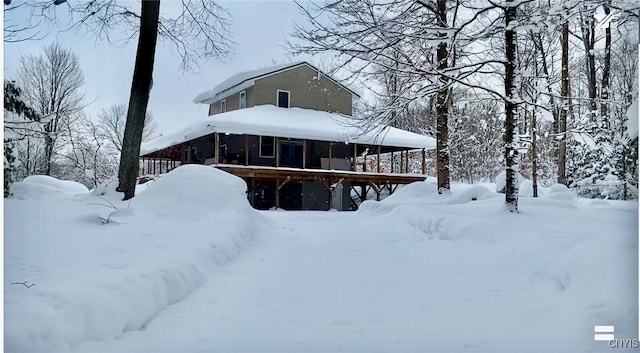 view of snow covered rear of property