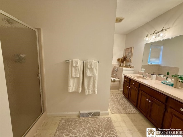 bathroom featuring a garden tub, vanity, a shower stall, and visible vents