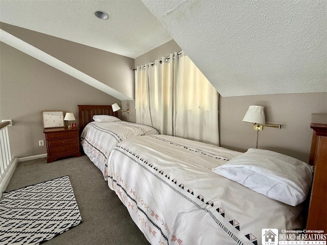 bedroom with dark colored carpet, vaulted ceiling, and a textured ceiling