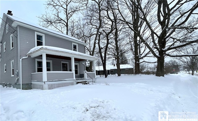 view of front of property with a porch and a chimney