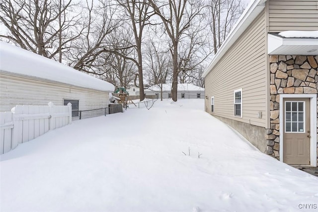 yard covered in snow with fence