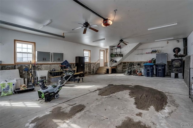 garage featuring ceiling fan and a garage door opener