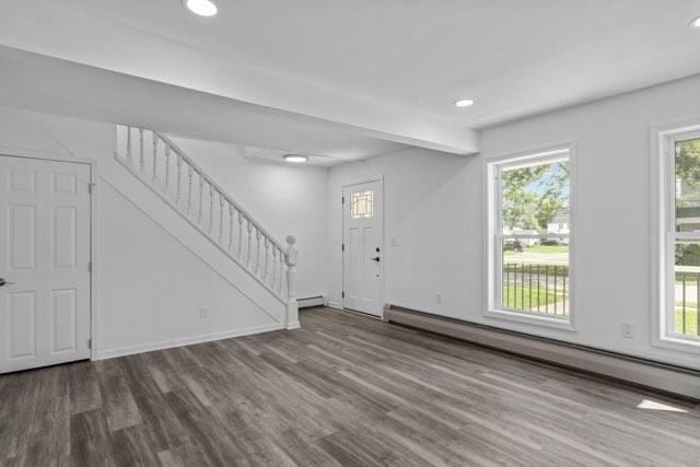 entrance foyer featuring recessed lighting, a baseboard heating unit, wood finished floors, baseboards, and stairs