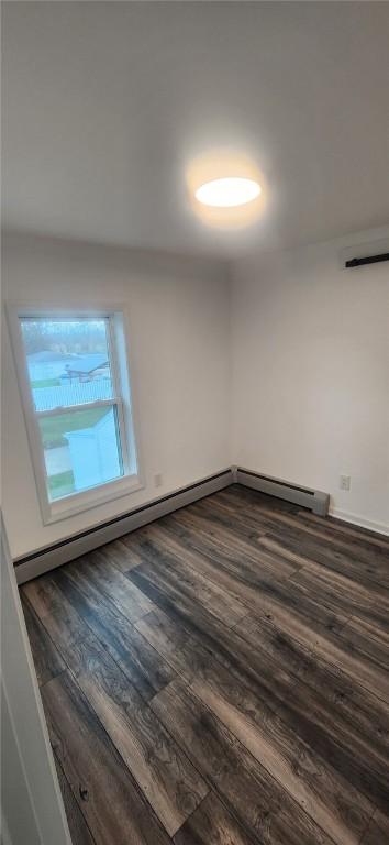 unfurnished room featuring dark wood finished floors