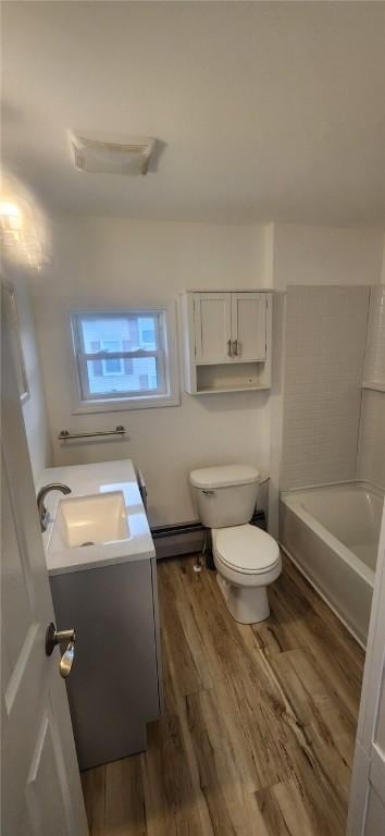 full bath with a baseboard radiator, vanity, toilet, and wood finished floors