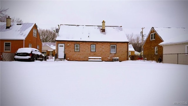 snow covered property featuring fence