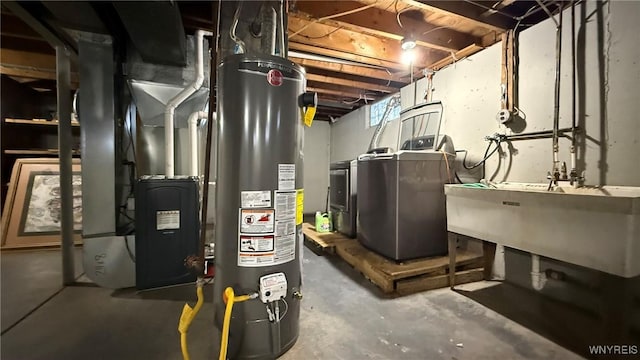 utilities featuring water heater, washing machine and dryer, a sink, and heating unit