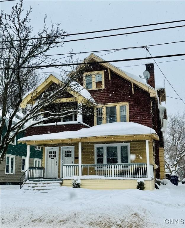 view of front of home with a porch and a chimney