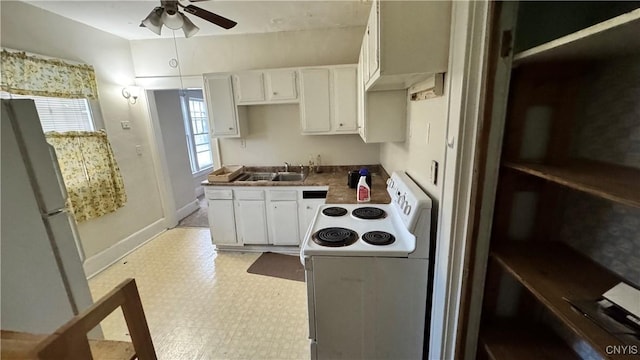 kitchen with ceiling fan, white appliances, a sink, white cabinetry, and light floors