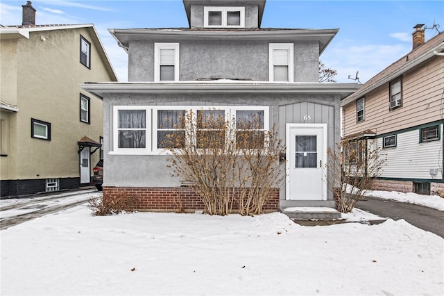 american foursquare style home with board and batten siding