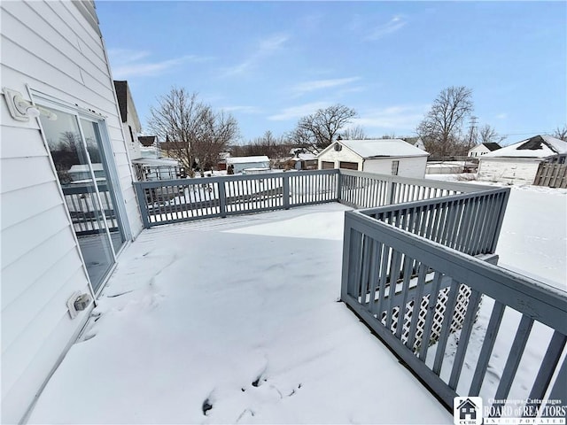 snow covered patio with a deck