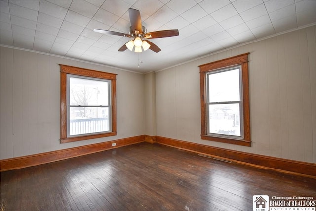 unfurnished room with baseboards, dark wood-type flooring, a ceiling fan, and crown molding