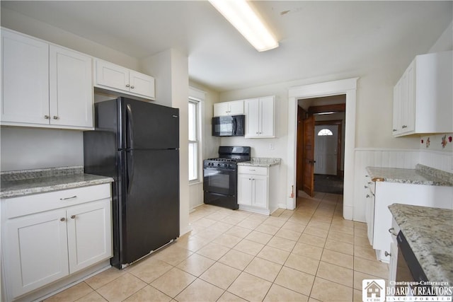 kitchen featuring white cabinetry, black appliances, and light tile patterned floors