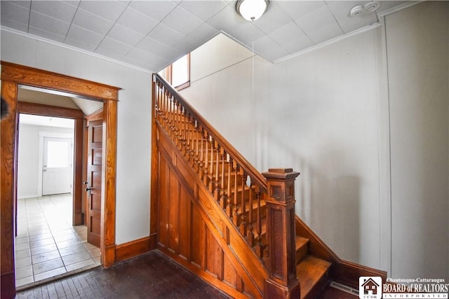 stairs featuring baseboards and ornamental molding