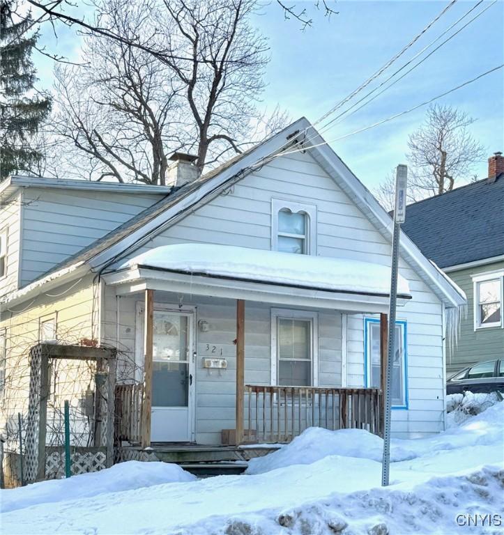 bungalow-style home featuring a porch and a chimney