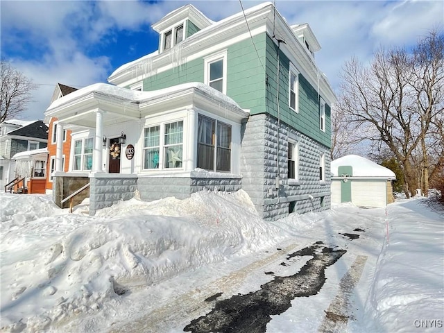 american foursquare style home featuring an outdoor structure and a detached garage