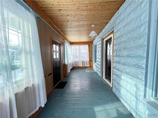 unfurnished sunroom featuring wood ceiling