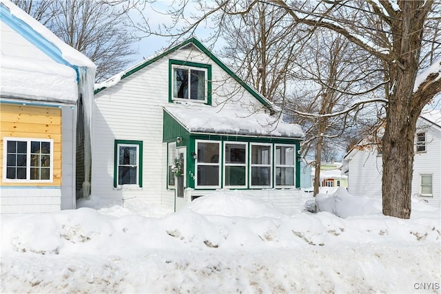 view of snow covered back of property