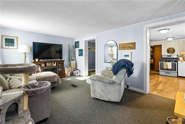 carpeted living room with baseboards and visible vents