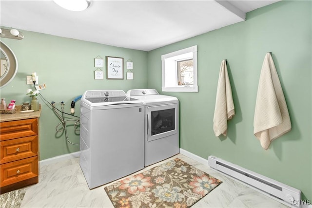 laundry room with laundry area, baseboards, a baseboard radiator, marble finish floor, and washing machine and dryer