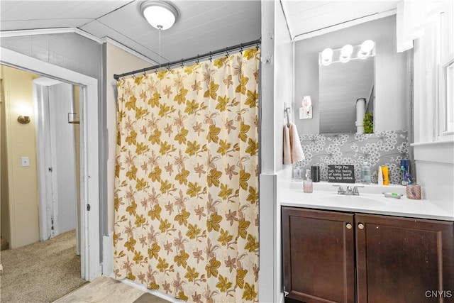 bathroom with vaulted ceiling and vanity