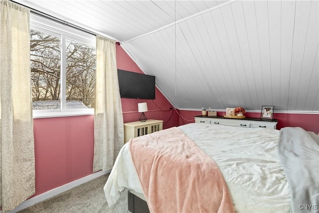 bedroom featuring carpet, multiple windows, vaulted ceiling, and baseboards