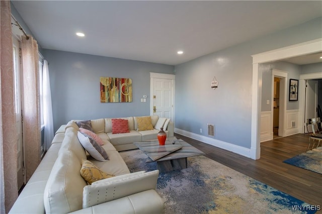 living room featuring baseboards, dark wood-style flooring, visible vents, and recessed lighting