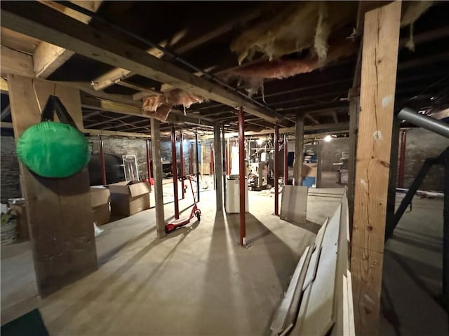 unfinished basement with washer and dryer and heating fuel