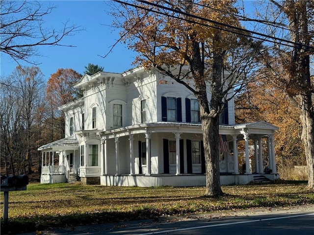 italianate-style house with a front lawn and a porch