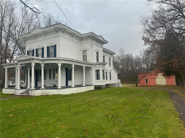 view of home's exterior with driveway, a porch, and a lawn