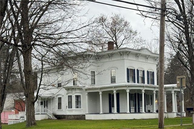 view of front of house with a front yard and a chimney