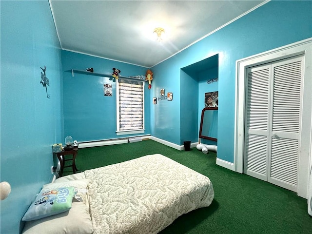 bedroom featuring baseboards, dark colored carpet, crown molding, a baseboard heating unit, and a closet