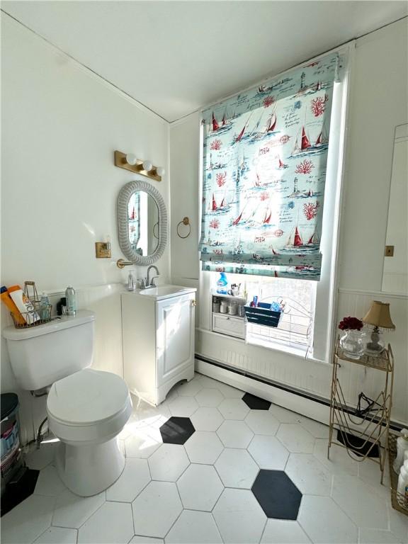 bathroom featuring toilet, vanity, and tile patterned floors