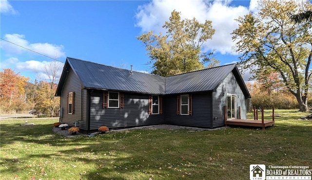 exterior space featuring metal roof and a lawn