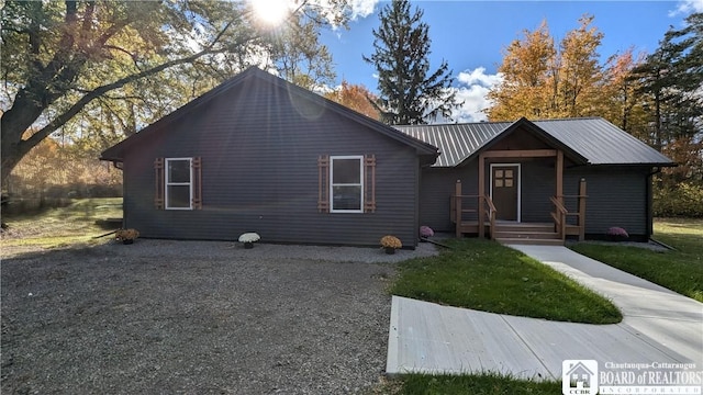 view of front of home with a front yard and metal roof