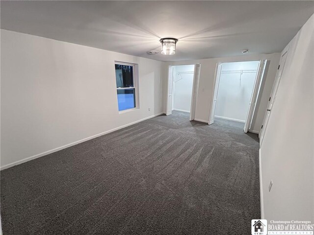 5417 Rte 5, Portland, NY 14769 - unfurnished bedroom with dark colored carpet, multiple closets, and baseboards