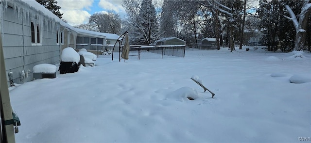 snowy yard with fence