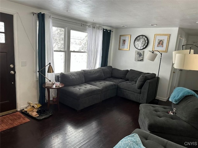 living room with dark wood-style floors and a textured ceiling