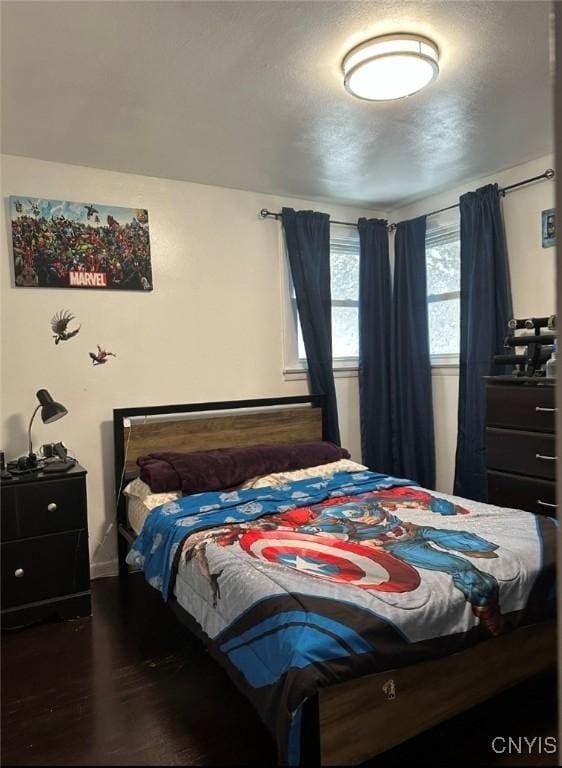 bedroom featuring dark wood finished floors